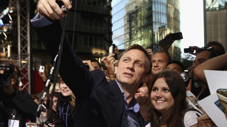 Daniel Craig taking photos with fans