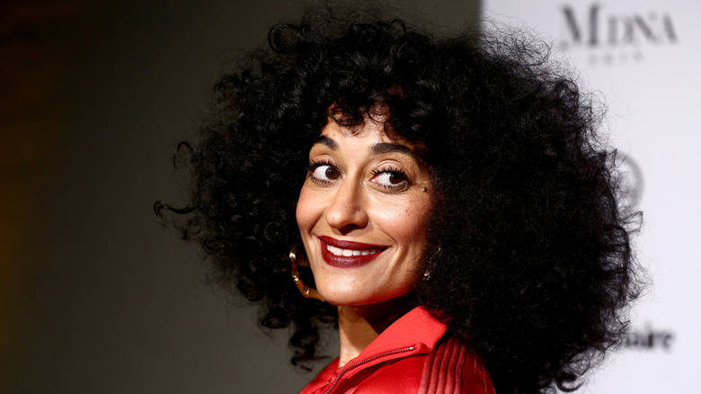 Tracee Ellis Ross smiling while looking over her shoulder