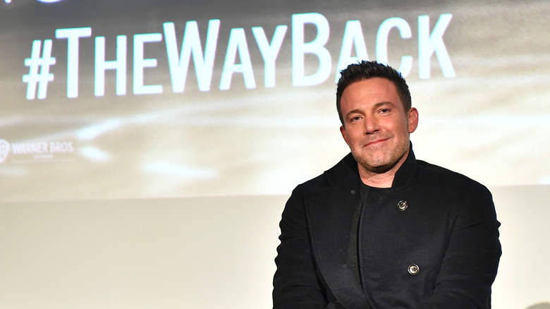 Ben Affleck smiling onstage at an event for The Way Back