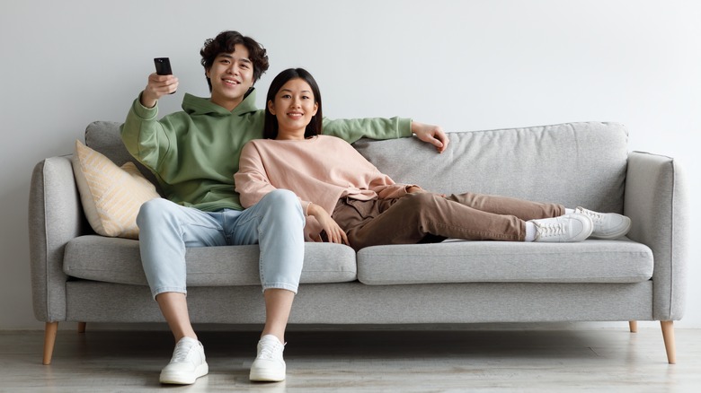 couple watching tv on couch