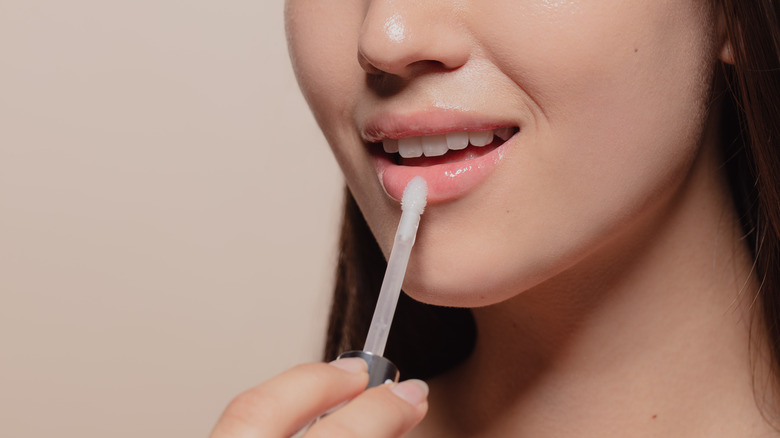 woman applying lip gloss