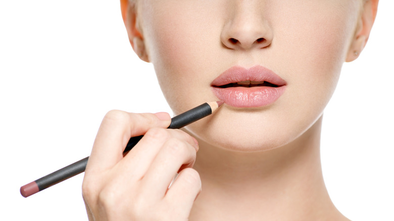 woman applying lip liner