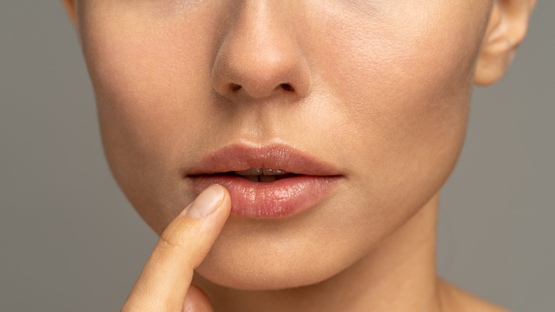 woman applying lip mask