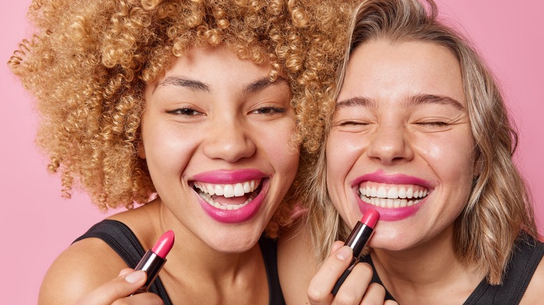 Two women smiling with lipstick