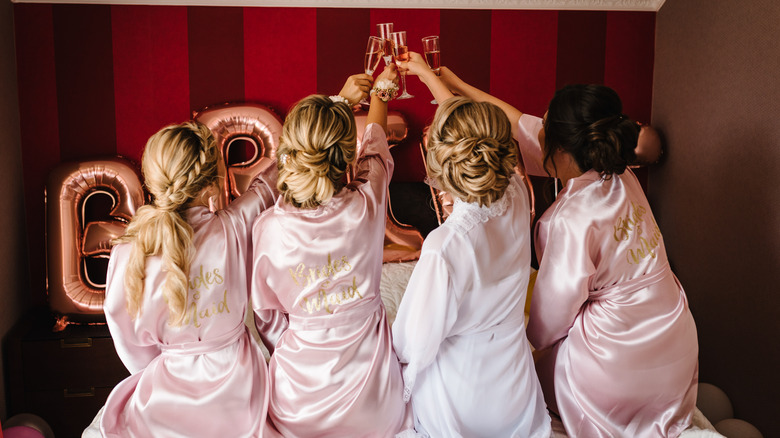 Bride and bridesmaids toasting champagne