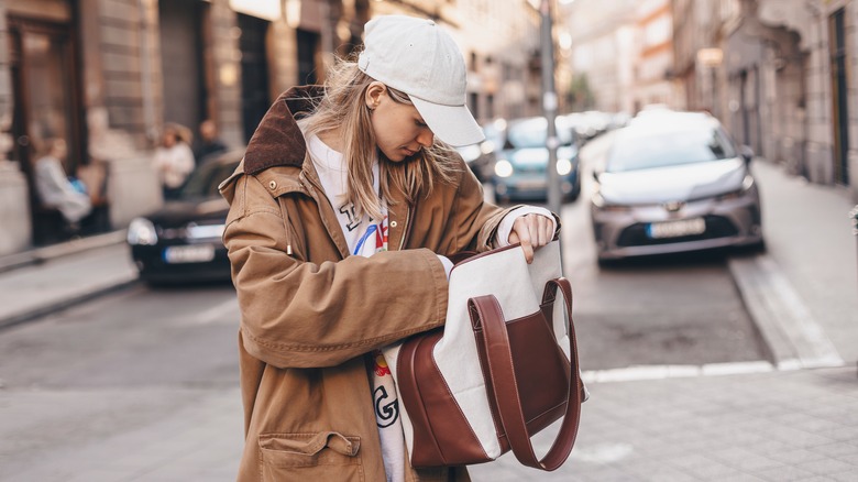 Woman looks in her purse