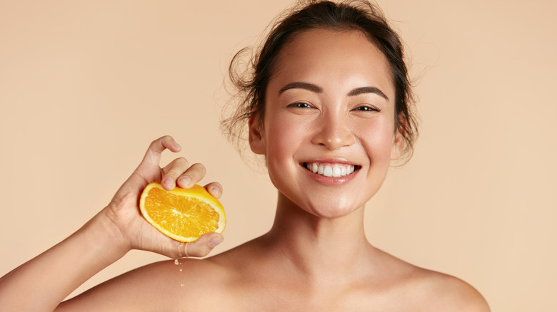 woman squeezing an orange