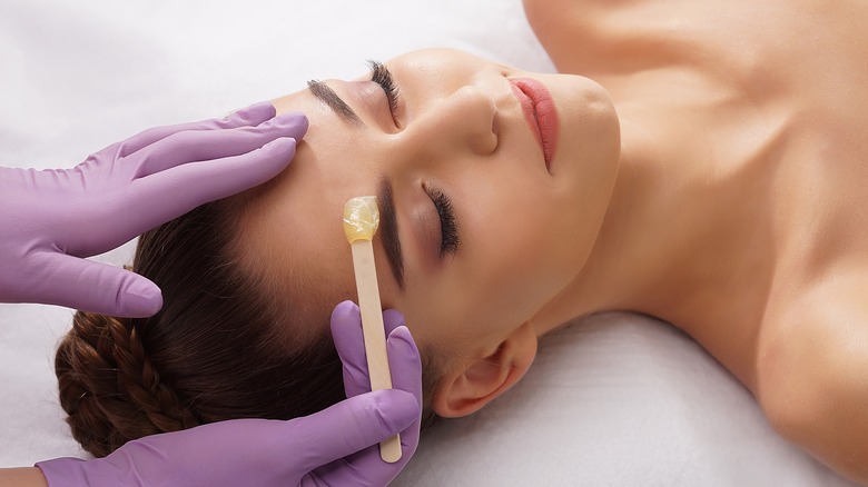 Woman getting eyebrows waxed 