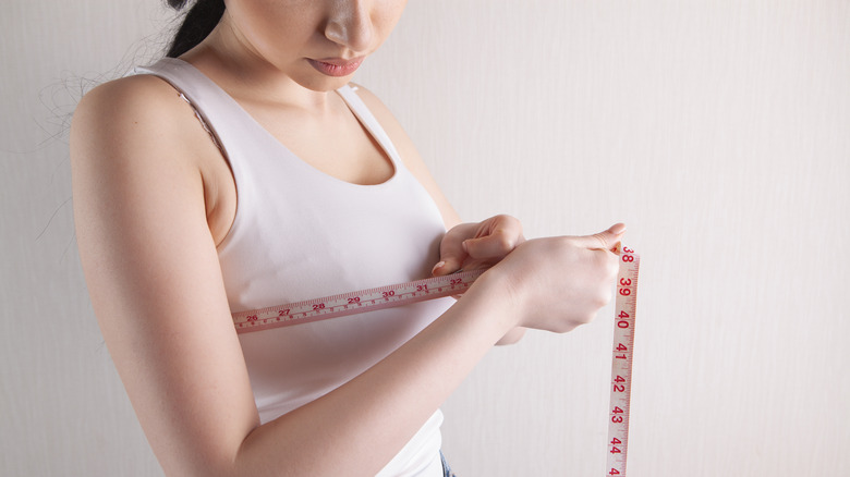 Woman measures her chest