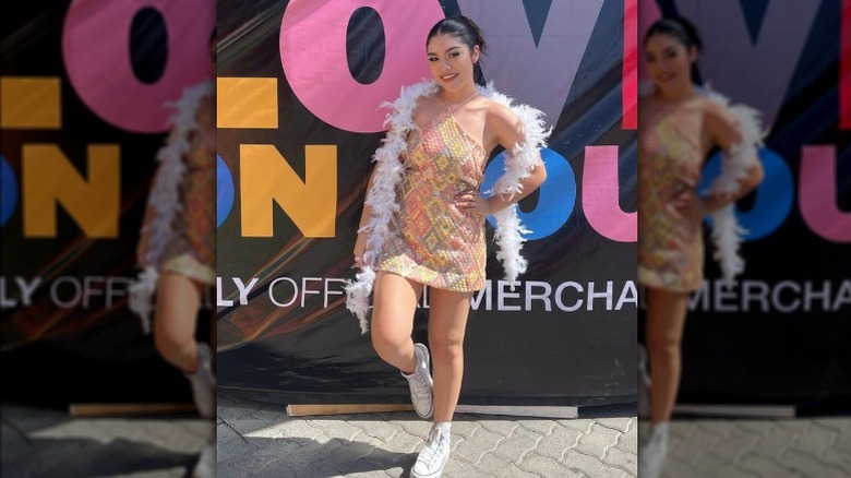 Woman posing in dress and feather boa