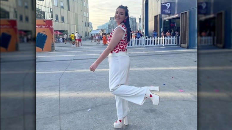 woman posing with heart-themed outfit