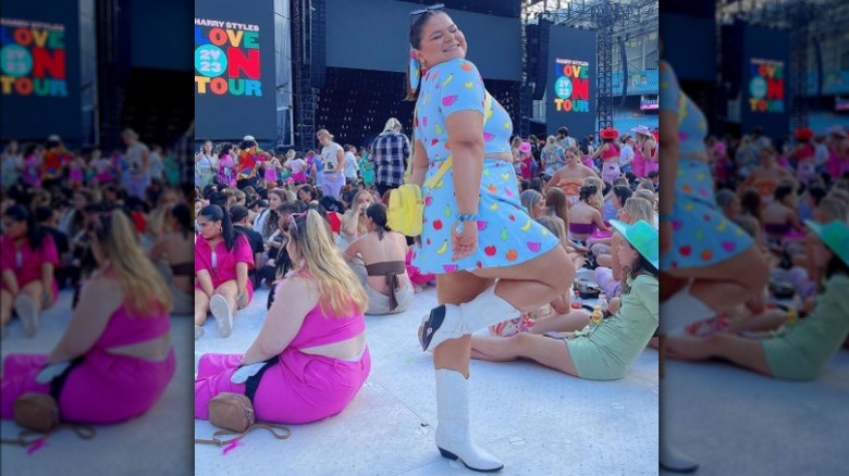 Woman at concert posing in colorful outfit