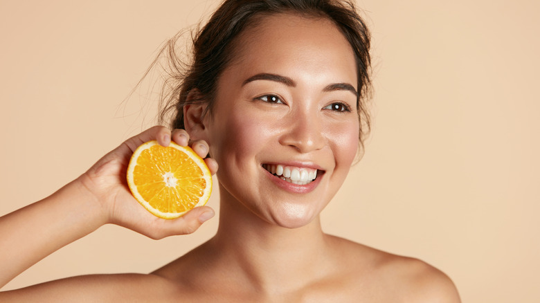 Woman holding orange