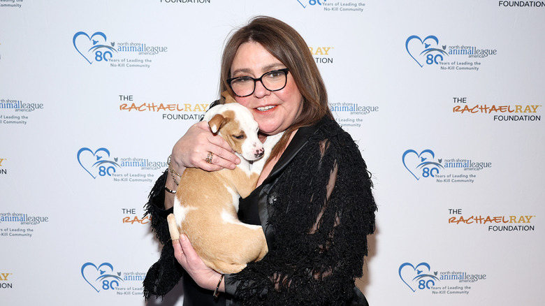 Rachael Ray holding a dog