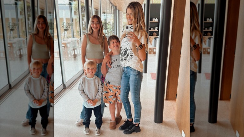 Christina Hall taking a mirror selfie with her three children