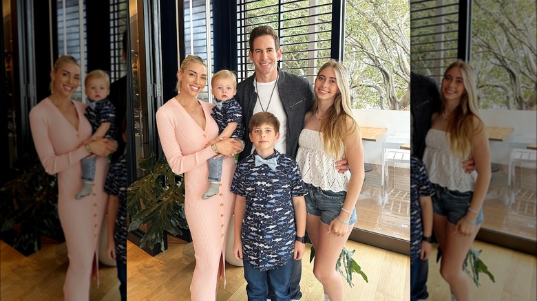 Tarek and Heather Rae El Moussa posing with their three kids for a family photo