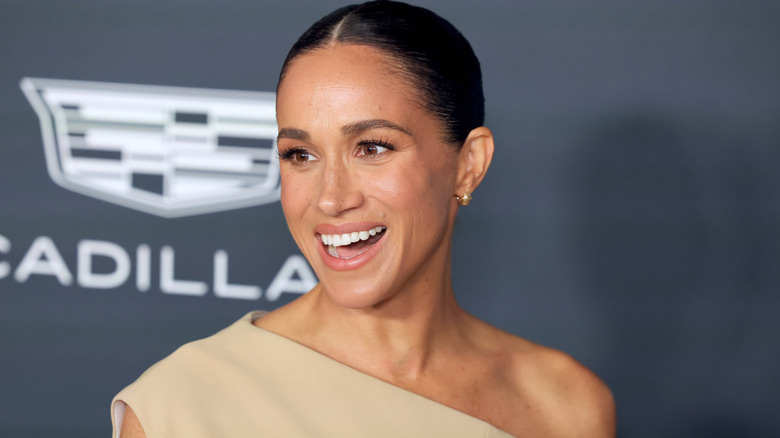 Meghan Markle smiling on the red carpet