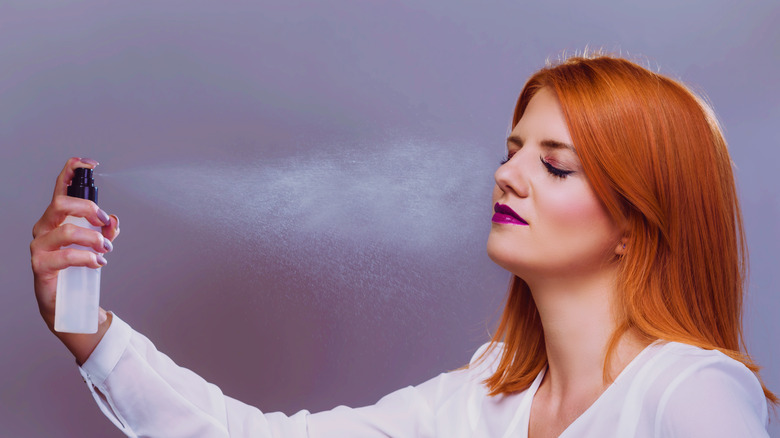 woman spraying face 