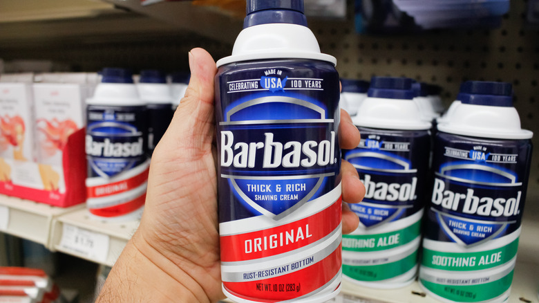 Hand holding can of Barbasol 