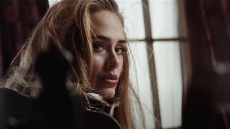 A screenshot of Adele looking windswept from her "Easy On Me" music video