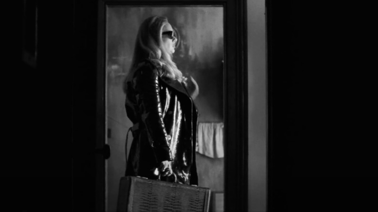 A screenshot of Adele with a suitcase from her "Easy On Me" video