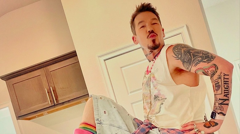 David Bromstad pursing his lips with his hand on his hip