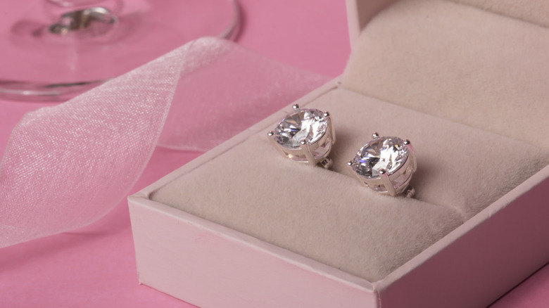 A pair of diamond earrings in a box