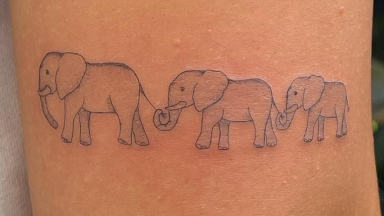 Small line of elephants tattoo 