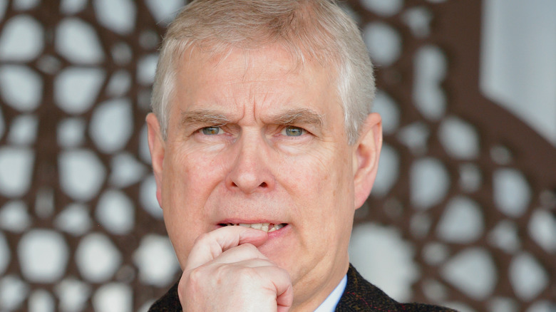 Prince Andrew with his finger in his mouth