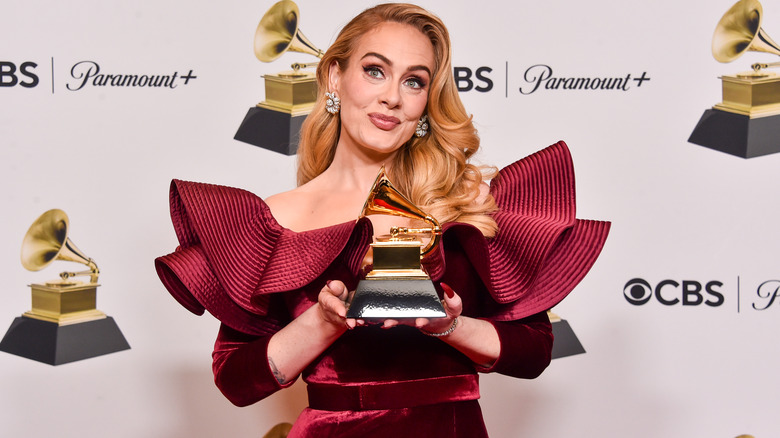 Adele holding Grammy Award