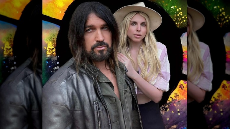 Billy Ray Cyrus and Firerose posing by stained glass