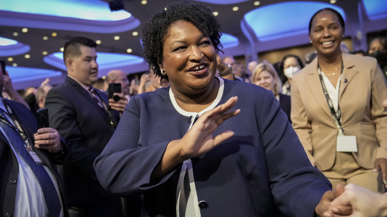 Stacey Abrams waving at voters