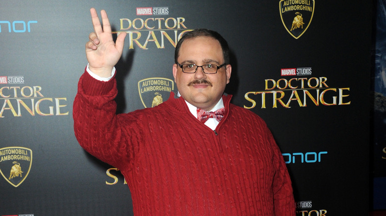 Ken Bone posing in a red sweater