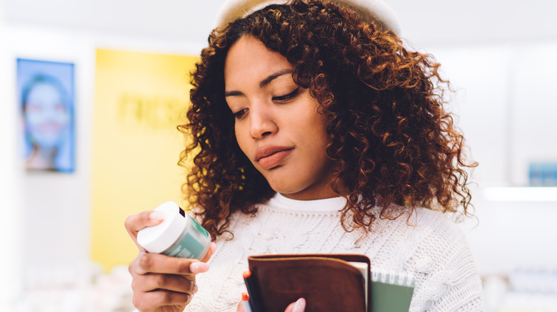 Woman reading product ingredients