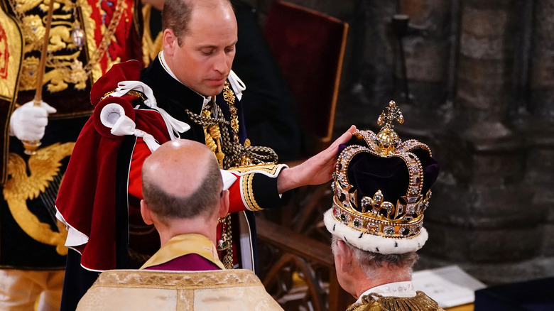 Prince William touches King Charles' crown during coronation