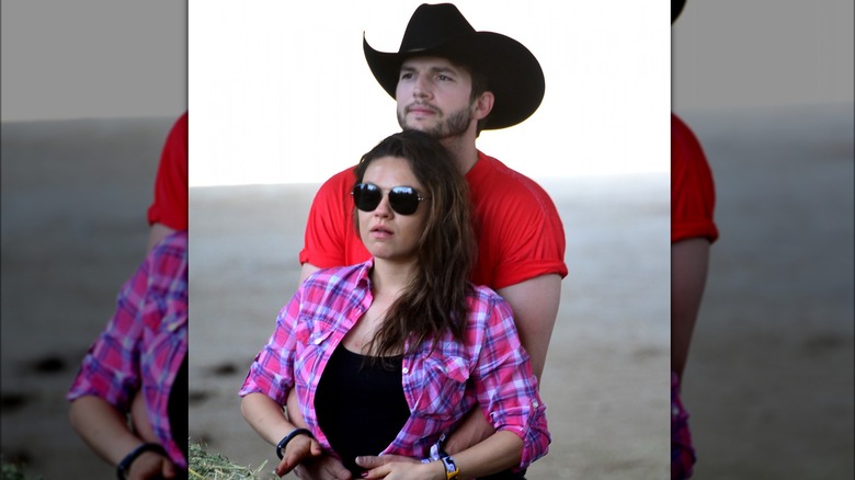 Ashton Kutcher hugs Mila Kunis.