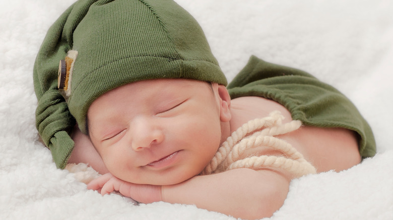 tiny baby in hat smiling