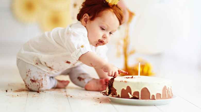 baby eating cake