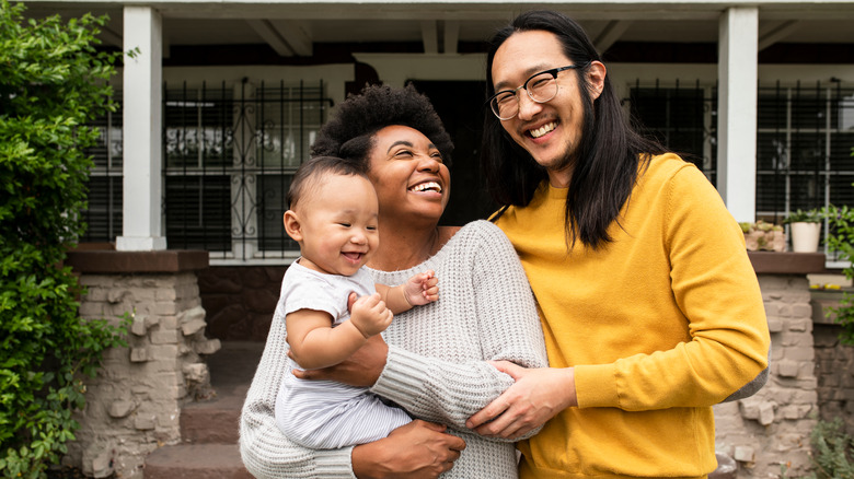 young family smiling and laughing