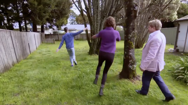 Homebuyers, realtor checking out backyard