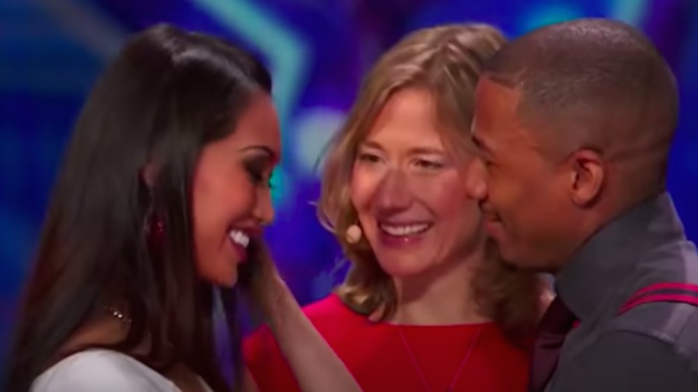 Nick Cannon with two women on America's Got Talent