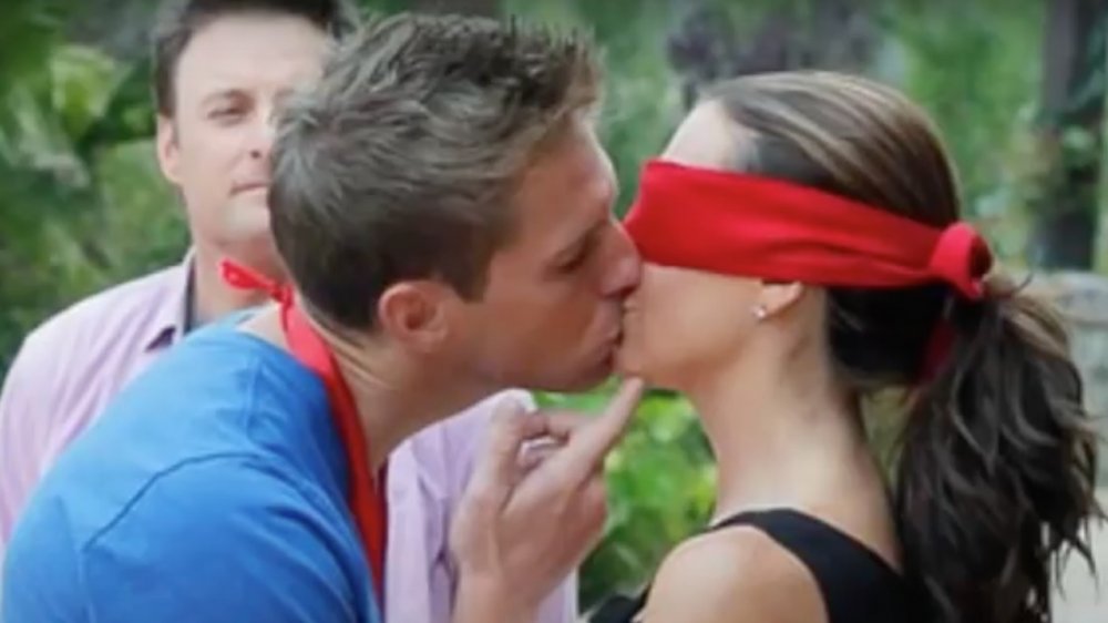 Two stars of The Bachelor Pad kissing, blindfolded