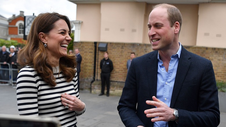 Prince William and Kate Middleton laughing at William's gaffe in an awkward royal family interview