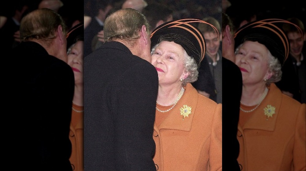 Queen Elizabeth and Prince Philip kissing at event