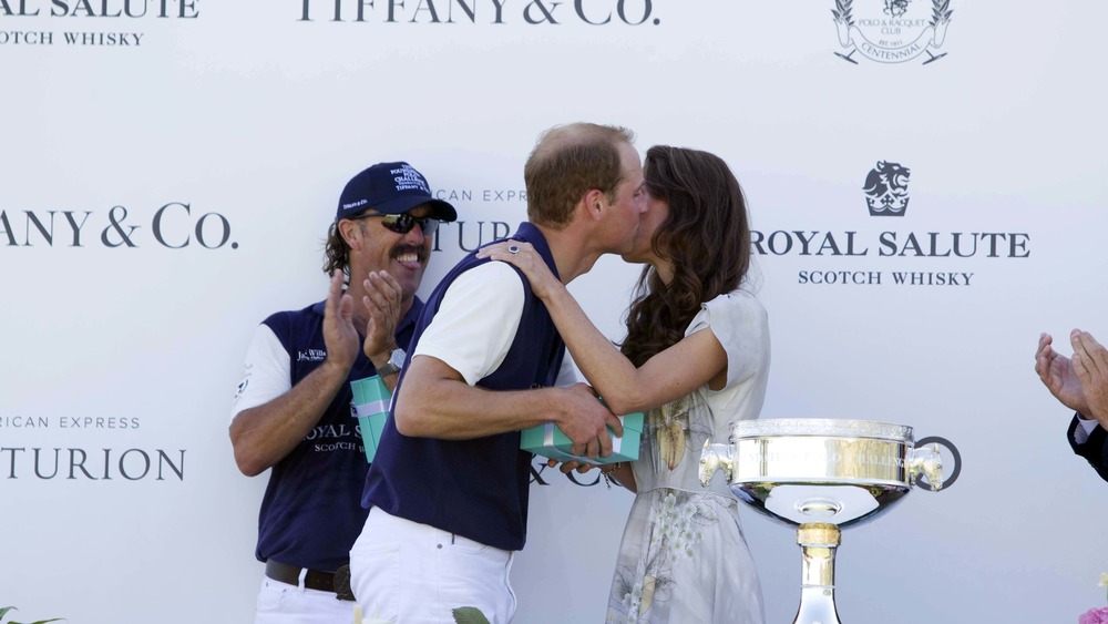 Prince William and Kate Middleton kissing at polo event