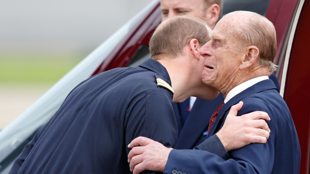 Prince William and Prince Charles embracing