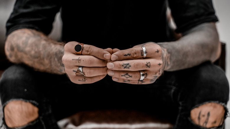 Tattoos on man's arms and hands