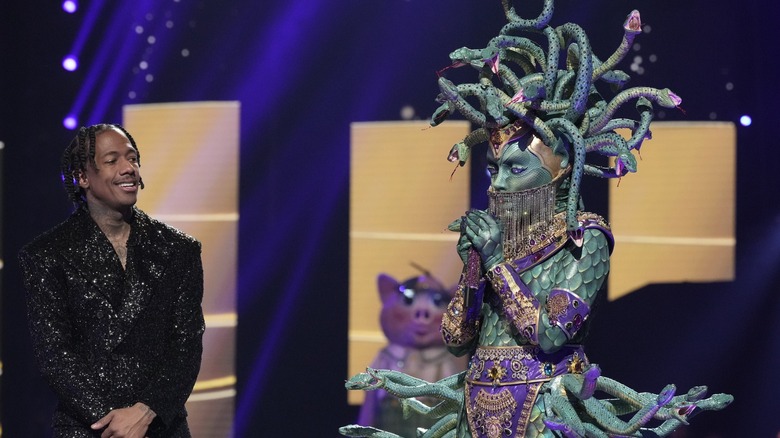 Nick Cannon and Medusa standing onstage