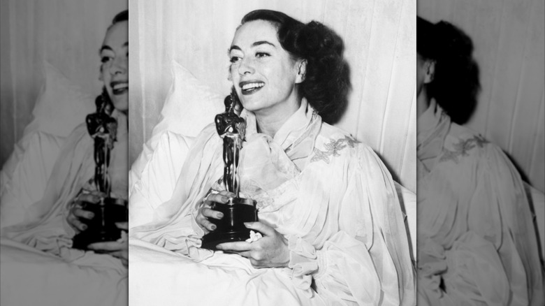 Joan Crawford accepting her Oscar in bed in 1946