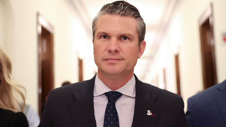 Pete Hegseth looking determined in a suit